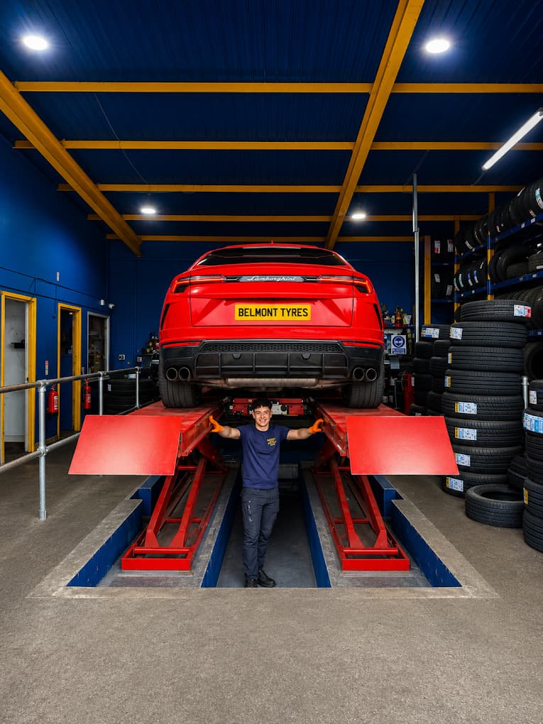 A car raised on Belmont Tyres' Hunter alignment rig in the Liverpool workshop